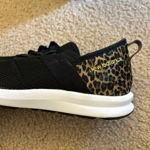 Animal print and black colored new balance sneakers